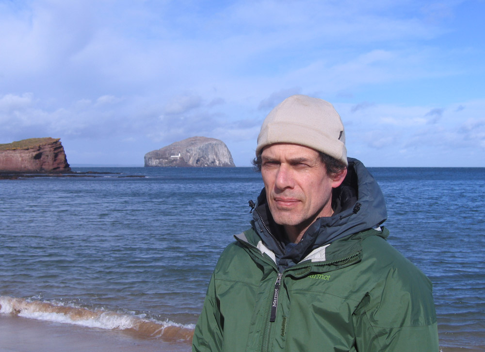 man with sea and Bass Rock
